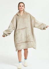 Khaki SnuglFit™ hoodie blanket worn by woman, oversized with large pocket and hood for comfort.
