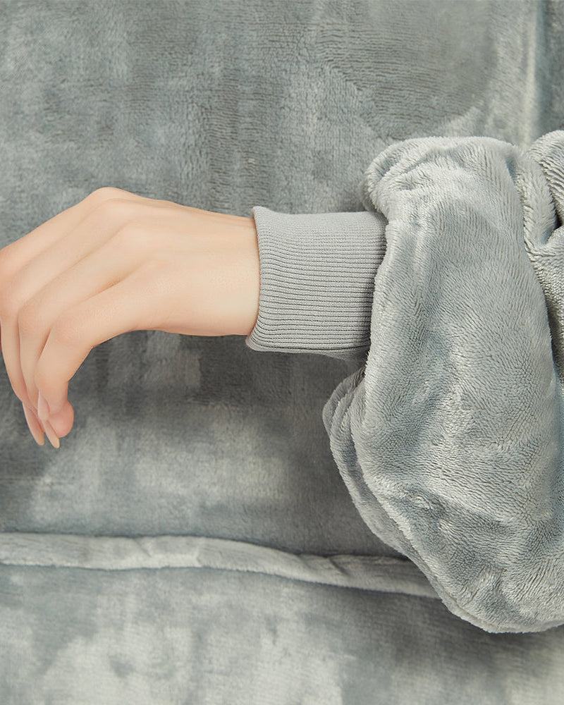 Light grey SNUGLFIT™ Hoodie Blanket showcasing plush fabric and comfortable cuff detail.