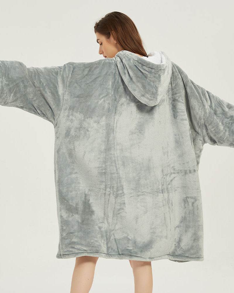 Light grey SNUGLFIT™ Hoodie Blanket with oversized fit, Sherpa fleece interior, and flannel fleece exterior, providing cozy warmth and style.
