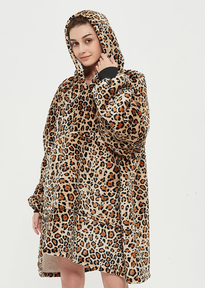 SNUGLFIT™ Hoodie Blanket in leopard print worn by a person, showcasing its oversized design and cozy hood.