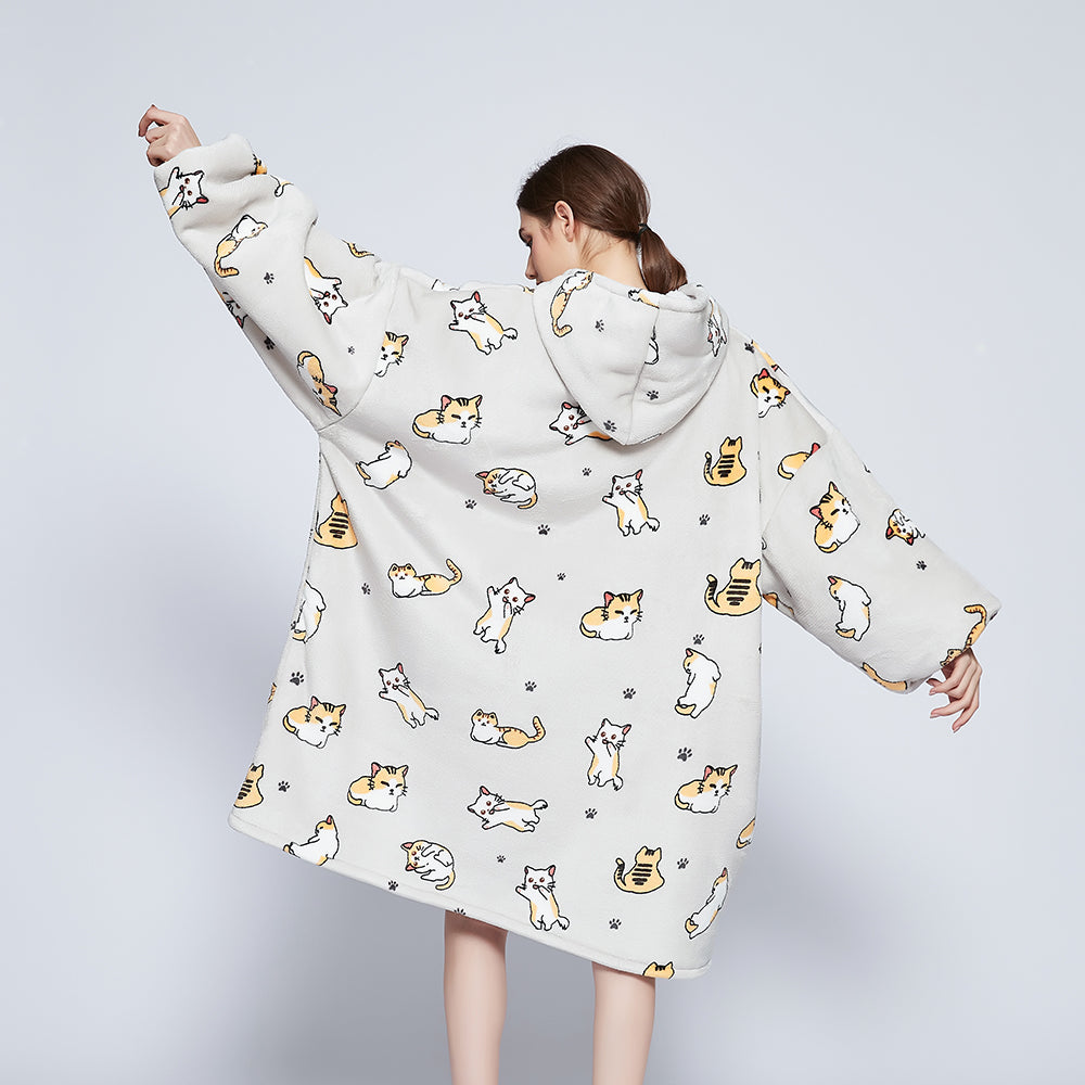Oversized SNUGLFIT™ Hoodie Blanket with kitten design, offering plush Sherpa fleece interior and SnuglTek™ flannel fleece exterior for warmth and comfort.