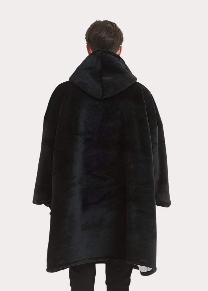 Hoodie blanket in midnight black worn by person showing back view.
