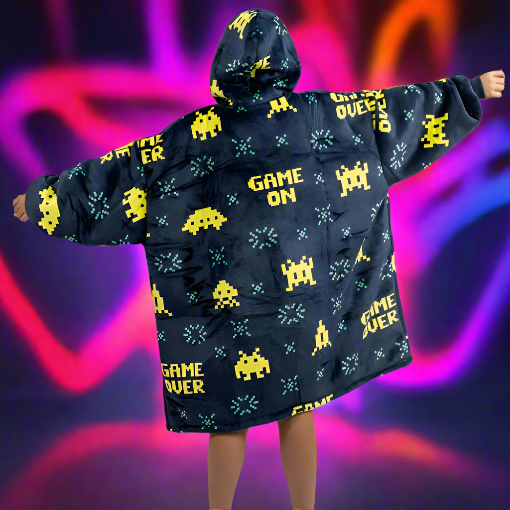 Kids wearing SNUGLFIT™ Hoodie Blanket with gamer design, colorful gaming graphics, oversized cozy fit.